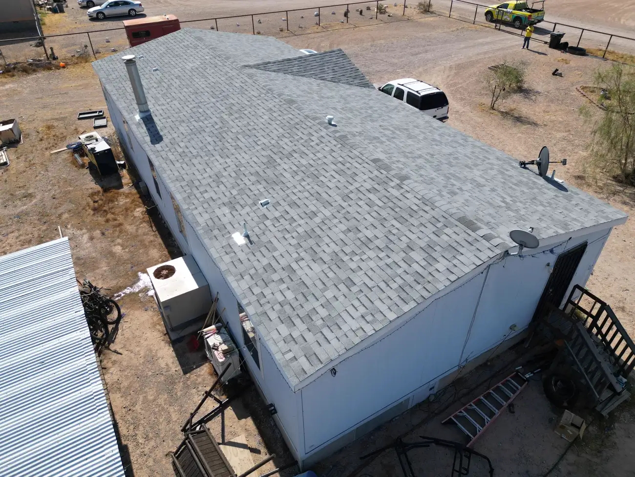 Aerial view of a completed shingle re-roof with the A1 Roofing crew on site