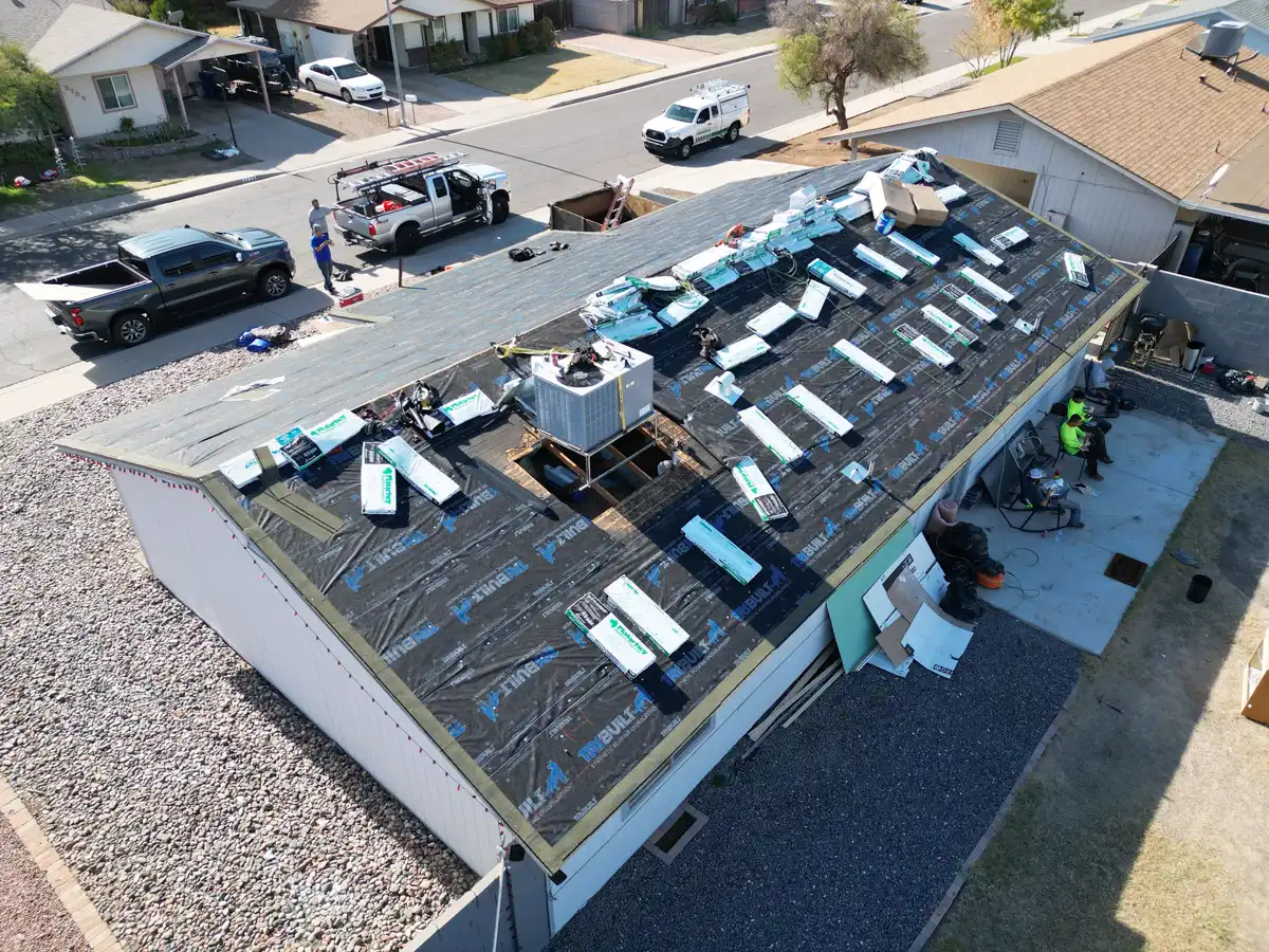 Aerial view of an A1 Roofing crew with tile stacks staged in courses on the underlayment
